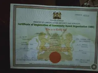A Kenyan government certificate of registration for a community based organization, with a red seal