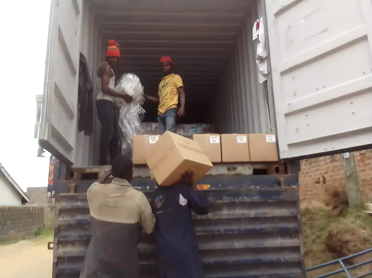 Workers passing boxes of books down from a truck